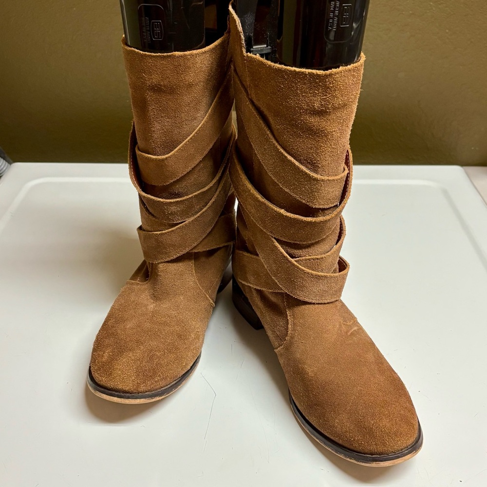 Restricted boots with decorative buckles